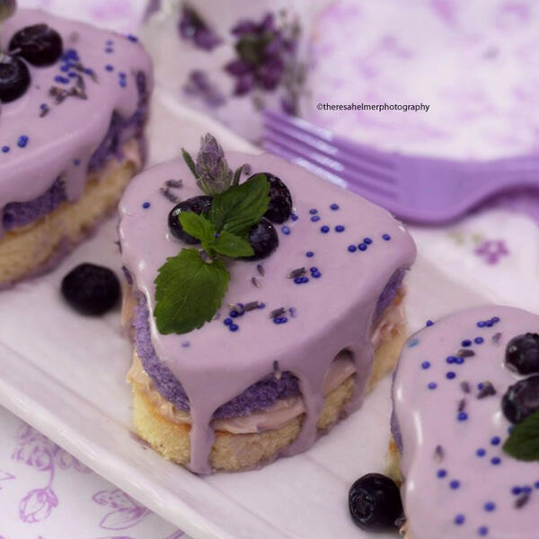 Lavender Hearts - Heart shaped blueberry and blackberry infused cakes with house made blueberry lavender white chocolate glaze decorated with lavender flowers, blueberries and a mint leaf.