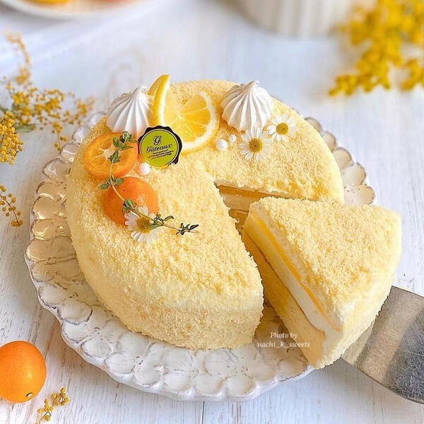 Lemon Custard Cake - A house made lemon cream custard between sweet lemon bread topped with lemon zest infused crumble, candied apricots, candied lemons and fresh whipped cream.