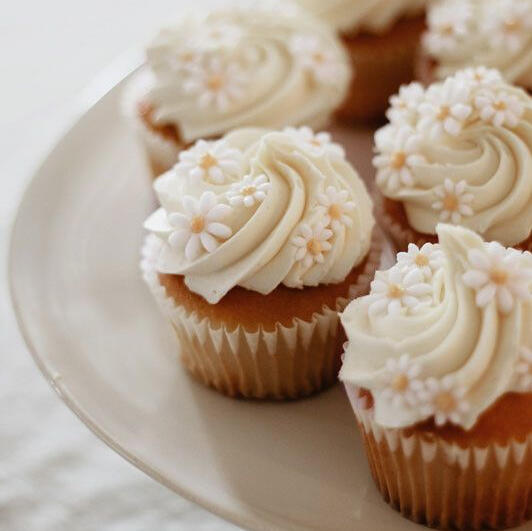 Chamomile Cupcake - Sweet house made vanilla cream frosting infused with high quality chamomile tea atop a black tea and honey cake decorated with handmade chamomile sugar flowers.