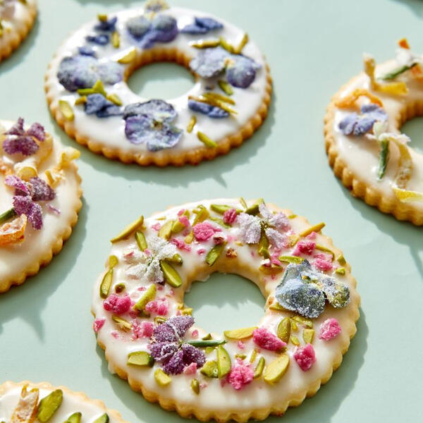 Garden Biscuits - Thin honey roasted biscuits soaked in sweet rum until diluted of alcohol coated in fresh house made vanilla jasmine glaze and edible sugar aged flower petals.