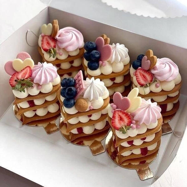 Berry Garden - Miniature variations of the garden bouquet these cakes are filled with house made chocolate whipped cream topped with vanilla whipped cream, various berries and berry wafers. o