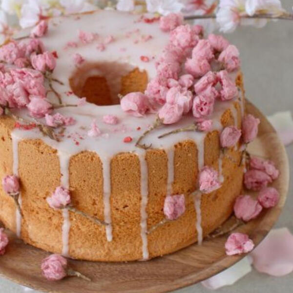 Floral Milk Tea Cake - Light pound cake soaked in fresh made milk tea coated in a cherry blossom flower infused glaze and decorated with candied cherry blossom flowers.
